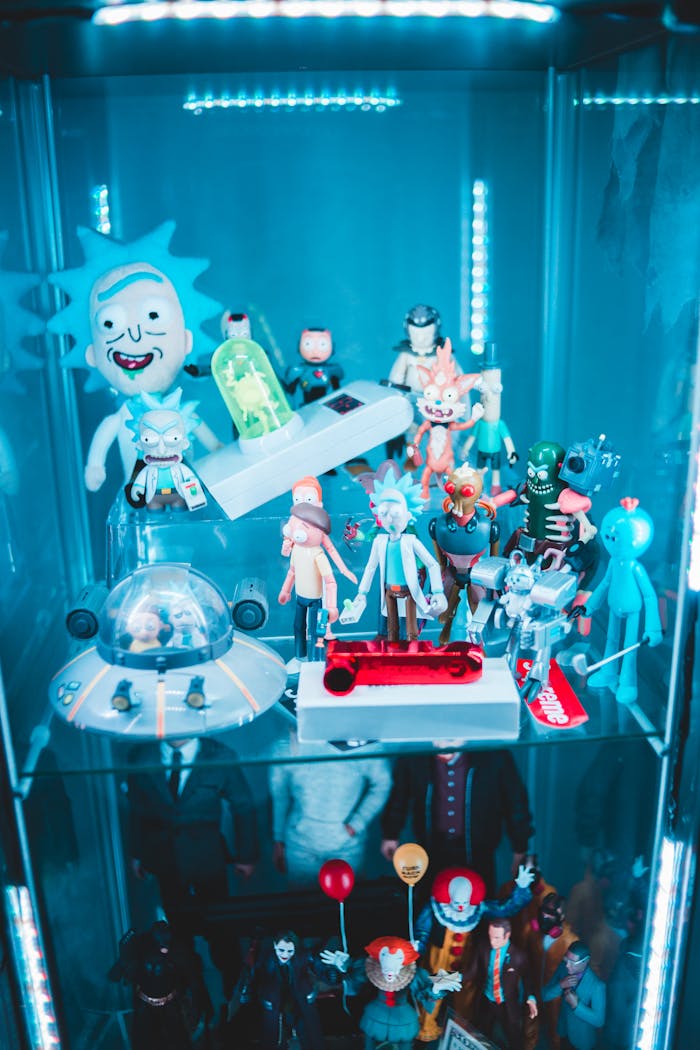 Vibrant collection of pop culture figurines displayed on illuminated glass shelves, featuring various characters.