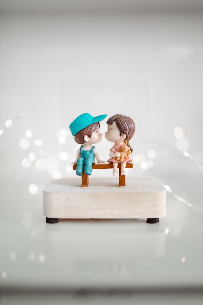 Charming couple figurines on a minimalistic white background, perfect for romance-themed decor.